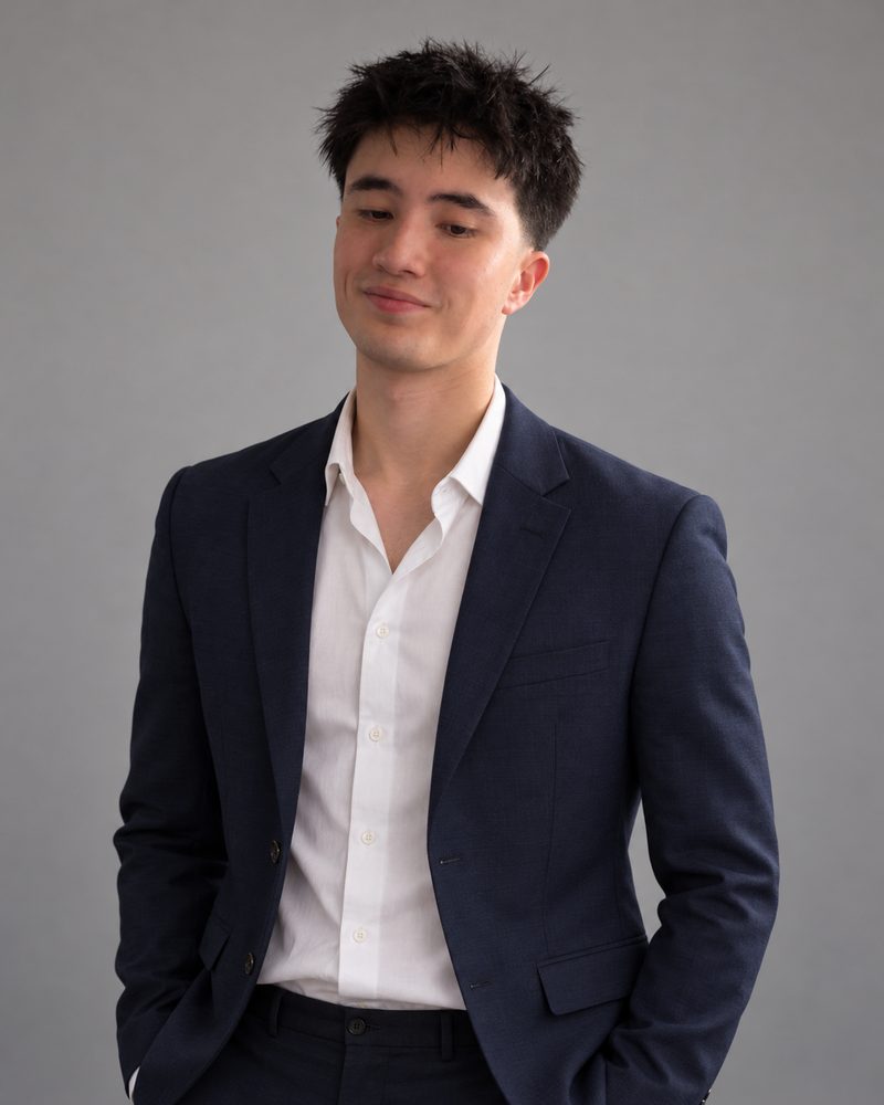 Joe, smiling, in a navy suit and white shirt